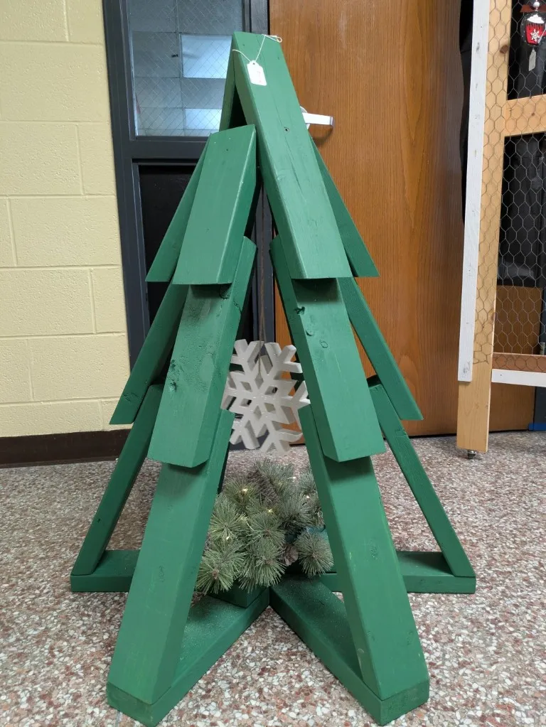 An alternative design for the 3ft wooden tree. It is painted green, has no lights, and has a snowflake at its base.